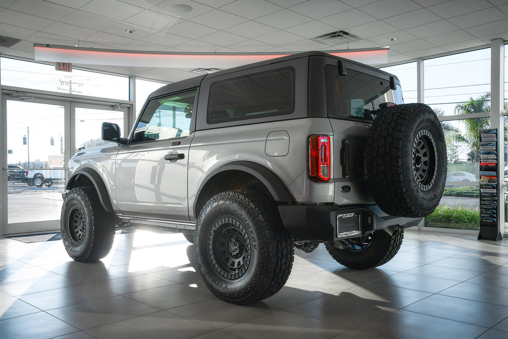 All New Lifted FORD Bronco 2 Door Silver with the HD Off-Road Wheels VENTURE Overland Sector Adventure style wheels in 17x9.0 with 35 inch all terrain tires.